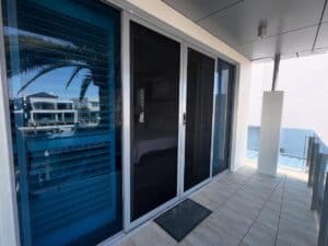 How the Crimsafe double doors blend seamlessly into the balcony facade - XL Security & Blinds